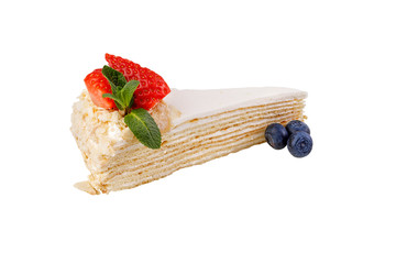 Cream puff pastry cake. Isolated on white background. Delicate delicious dessert decorated with fresh strawberries and blueberries.
