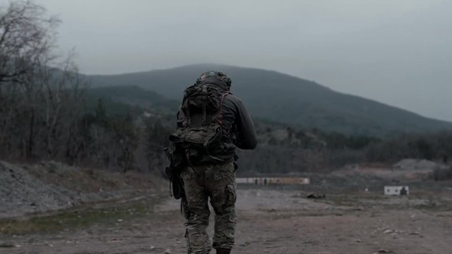 Special Forces trooper moves forward in a tactical manner with weapons
