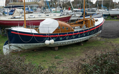 Vinatge life boat out of water in a boatyard
