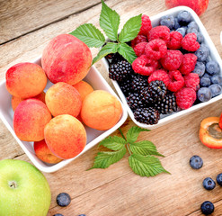 Healthy eating - fresh organic berry fruits and apricot in bowl