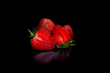 Tasty natural Ripe red strawberries on a black background