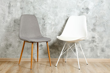 Empy loft style chair over blank wall background wit a lot of copy space for text. Available job...