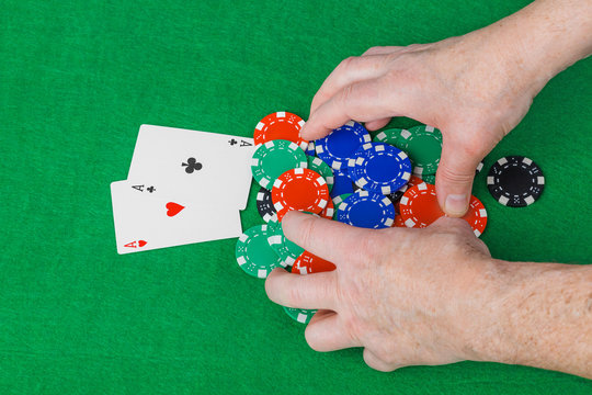 Hands with playing cards in casino