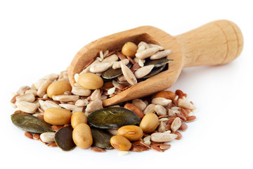 Mix of various healthy seeds including soy beans, sesame, pumpkin and sunflower seeds in wooden...