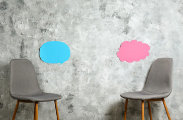 Empy loft style chair over blank wall background wit a lot of copy space for text. Available job...