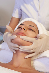 Young woman with perfect skin, towel on head, beauty photo concept, skin care, spa concept, treatment, facial massage.