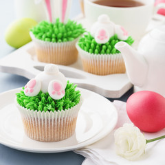 Easter bunny butt and ears cupcakes with eggs and tea.
