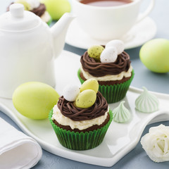 Easter chocolate cupcakes decorated with nest and candy eggs.