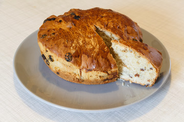 Kouign des gras cake with a piece cut on a dish
