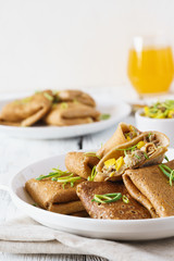 Rye crepes with corn and turkey filling. Healthy eating concept.