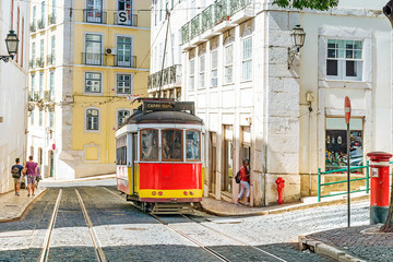 Fototapeta premium Lisbon, Portugal.Red retro streetcar in the streets in Lisbon