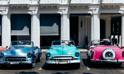 Vintage american cars parked on the street near Central Park in downtown Havana,