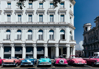 Vintage american cars parked on the street near Central Park in downtown Havana,