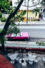 Vintage pink car parked on the street in downtown Havana