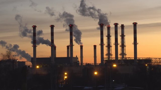 industrial landscape, the pipes of the thermal power plant at sunset