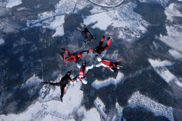 Formation skydiving.  A group of skydivers is in the sky.