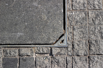 Manhole cover cobblestone pavement detail surface texture