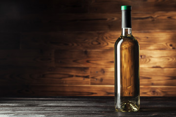 Fototapeta na wymiar bottle of wine over wooden background