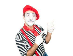 grimacing mime pointing aside isolated on white background.