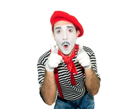 grimacing mime pointing at camera isolated on white background.