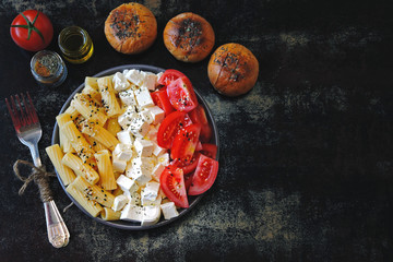 Colorful healthy super food bowl. Flat lay. Pasta, feta cheese and tomatoes.