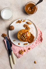 Pancakes with sweet caramel on white plate