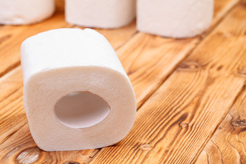Toilet paper roll close up on wooden background