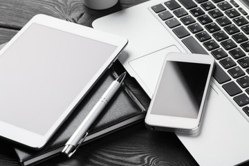 Open laptop with digital tablet and smartphone close up