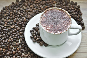 cup of coffee on the background of coffee beans