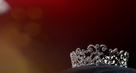 Silver Diamond Crown of Miss Pageant Beauty Universe World Contest sparkle light on black pillow, ready for wear Most beautiful Winner, studio lighting super red gradient background dramatic © Jade