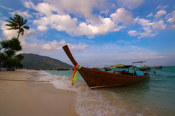 fishing boat is parked on the shore of the beach