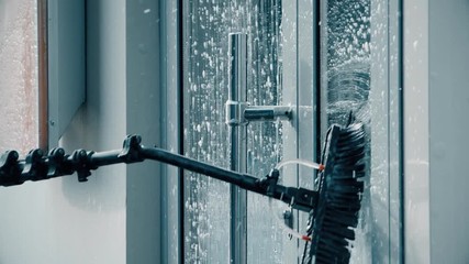 Window washer cleaning building facade