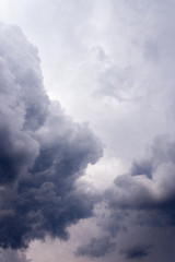 Pre-storm gloomy gray, purple, dark blue sky, covered with solid fluffy clouds. The forerunners of the rain in the sky prepare for the weather to deteriorate.