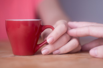 Fototapeta na wymiar male hand touches female hand with a cup of coffee flirting, courting, love