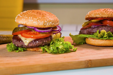 Hommemade fresh tasty hamburgers with cheese and tomato
