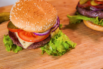 Hommemade fresh tasty hamburgers with cheese and tomato