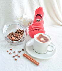 coffee with coffee beans and a red napkin