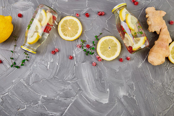 Detox water in bottles with cranberrie, ginger, lemon, mint