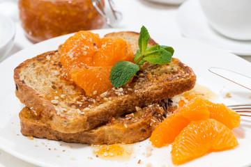 French toast with jam and tangerines for breakfast, closeup