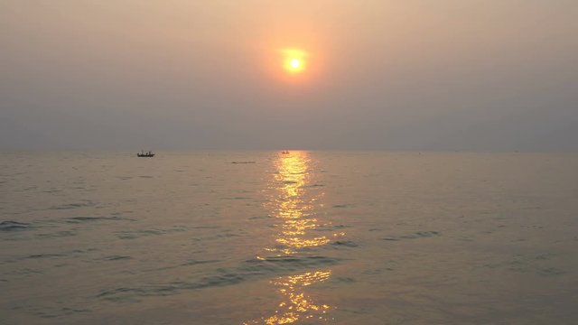 Sunrise and sunset on sea with fishing boat at Hua Hin beach Prachuap Khiri Khan Thailand.