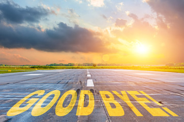 Good luck written on runway road airport at sunset
