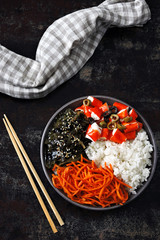Colorful poke a bowl with seaweed and crab meat. Vegetarian poke bowl. Top view.