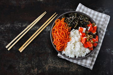 Colorful poke a bowl with seaweed and crab meat. Vegetarian poke bowl. Top view.