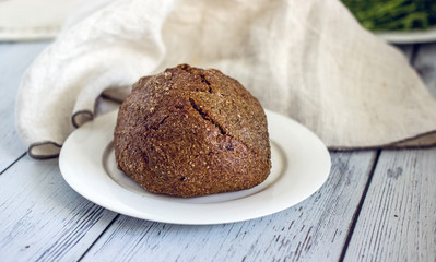 Wholegrain low-calorie bread with flaxseeds from wheat, rye and barley seedlings. Healthy bread for a healthy diet