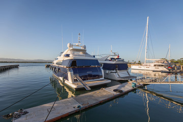 Philippines Mactan Island Yacht club marina on a blue sky day in a tranquil scene with reflections in water