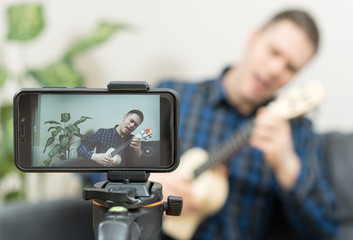 Handsome man recording song. Vlogging concept.