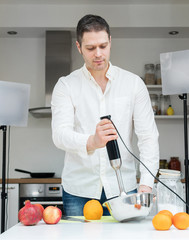 Man on the kitchen filming video for internet. Vlogging concept. © M-Production