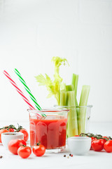 Glass of tomato juice and celery stems