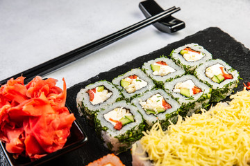 Big sushi set with variety of sushi rolls,on stylish dark background.
