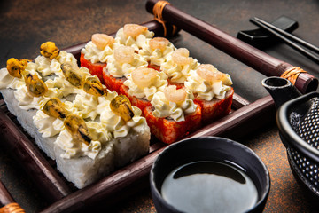 Big sushi set with variety of sushi rolls,on stylish dark background.